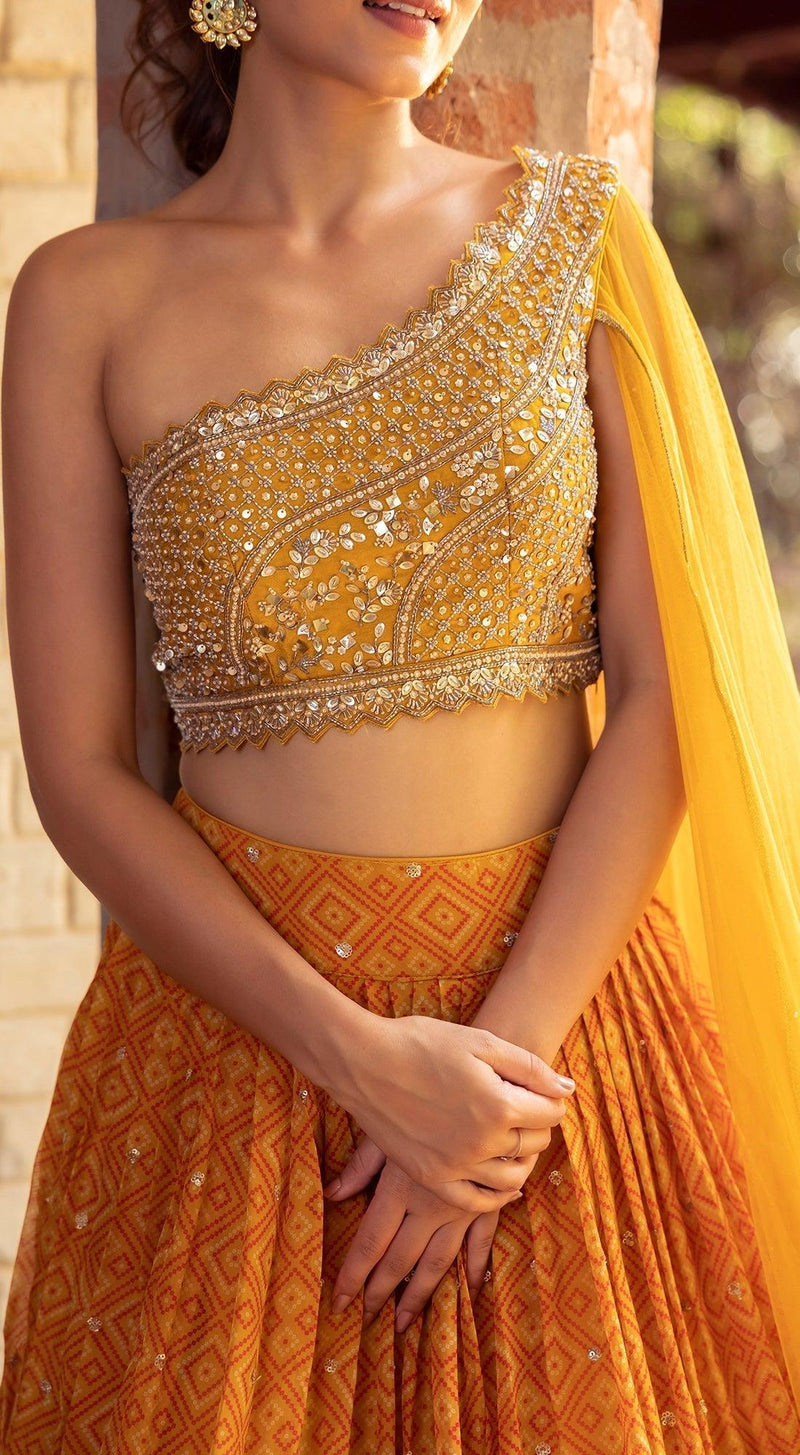 Three tier lehenga with one shoulder blouse
